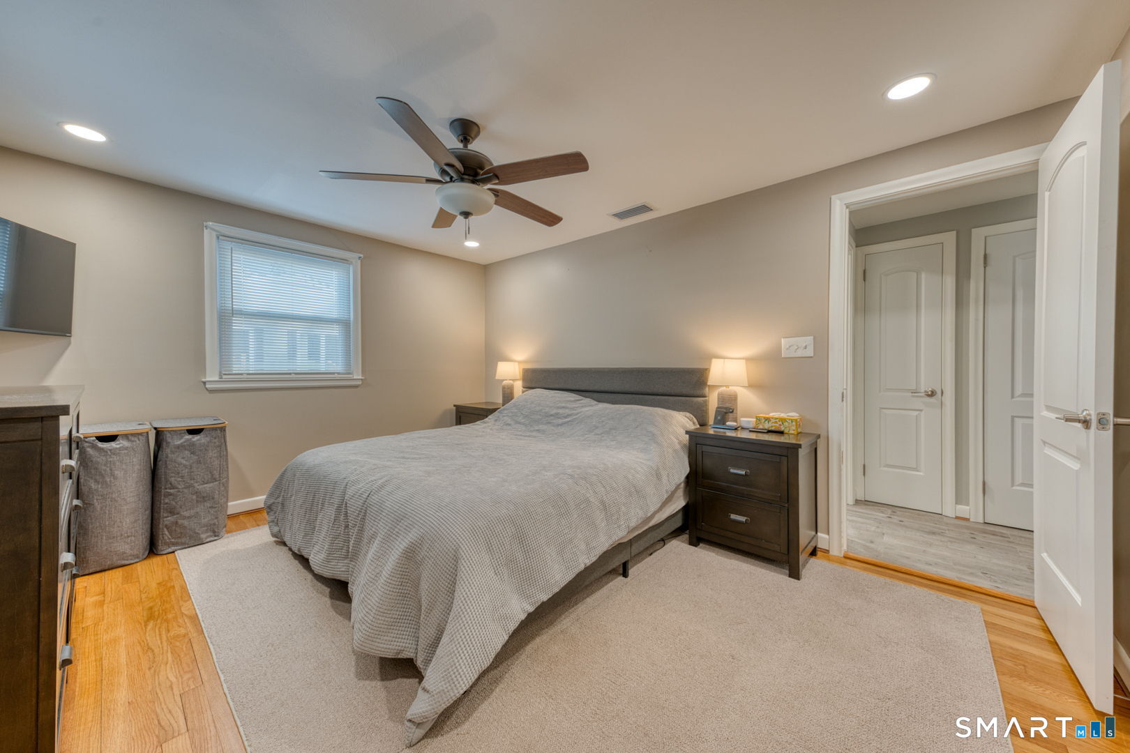 42 Northbrick Lane Wethersfield, CT 06109 - Photo 25 of 37 a bedroom with a bed and a chandelier
