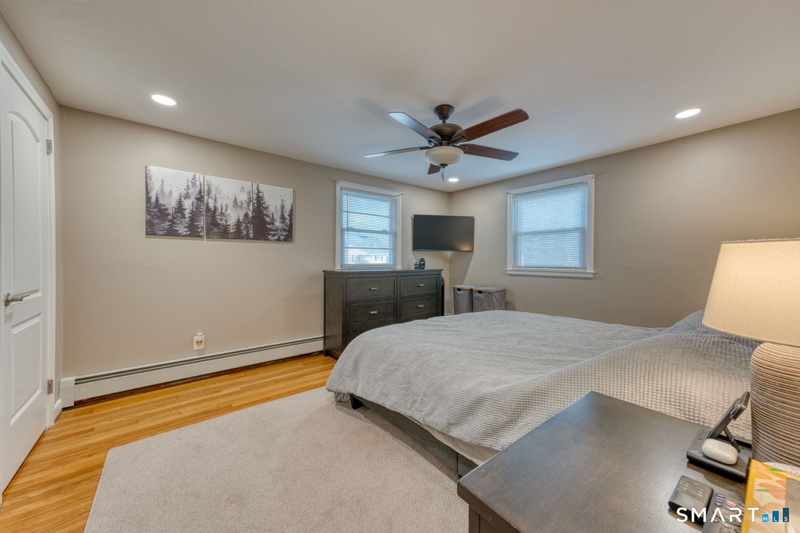 42 Northbrick Lane Wethersfield, CT 06109 - Photo 26 of 37 a bedroom with a large bed and a chandelier