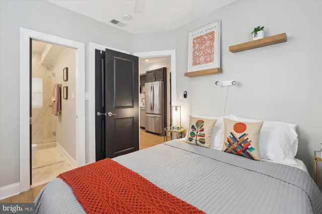 a bedroom with a bed and a painting on the wall