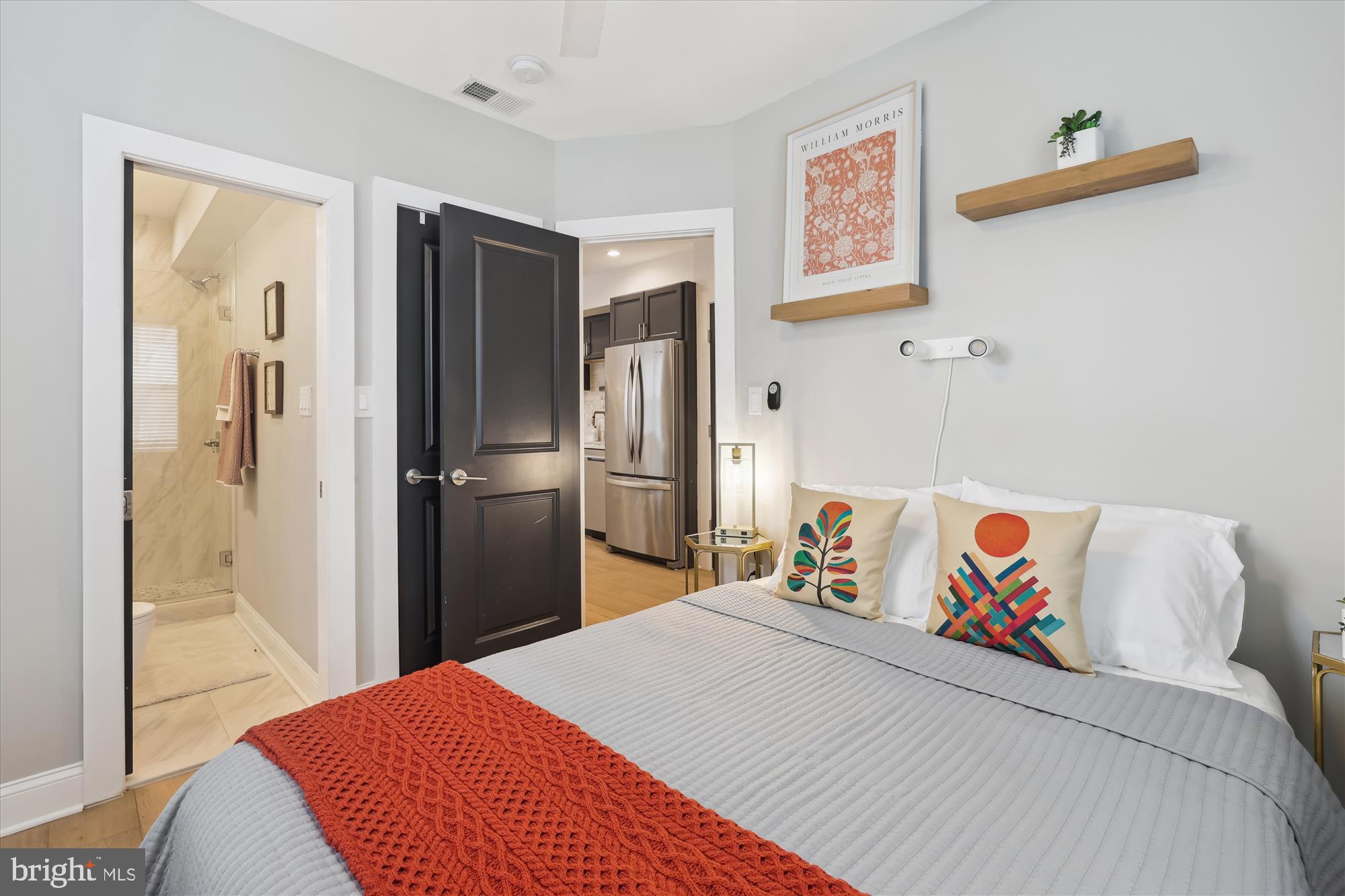 200 Hamilton Street Northwest, Unit 2 Washington, DC 20011 - Photo 12 of 16 a bedroom with a bed and a painting on the wall