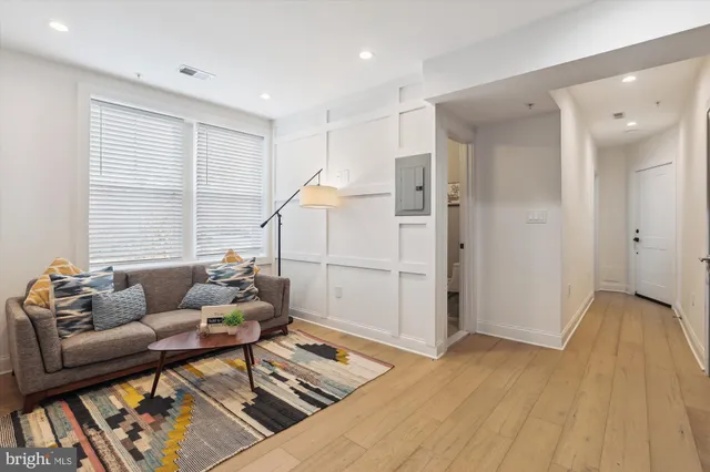 a living room with furniture and wooden floor