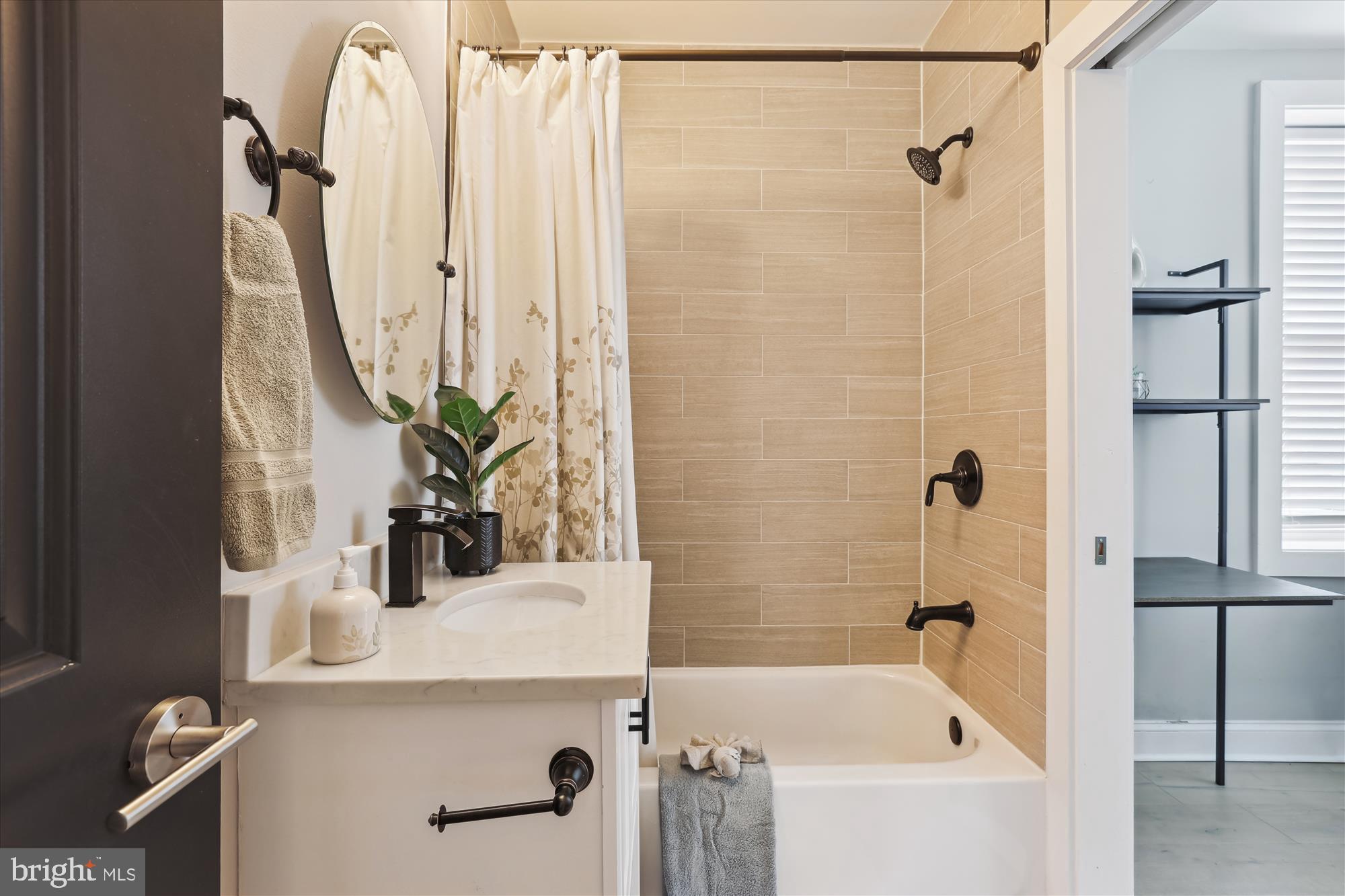 200 Hamilton Street Northwest, Unit 2 Washington, DC 20011 - Photo 10 of 16 a bathroom with a tub sink and mirror