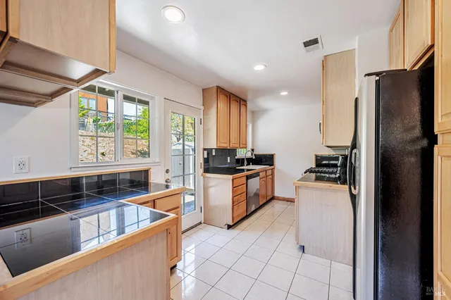 a view of a refrigerator in kitchen and wooden floor