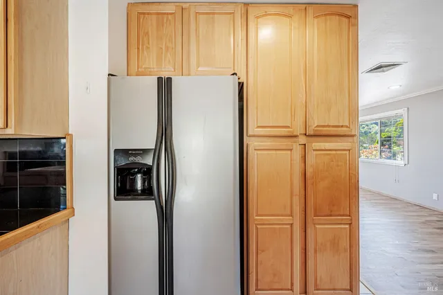 a kitchen with stainless steel appliances granite countertop a refrigerator a sink a stove and a microwave oven