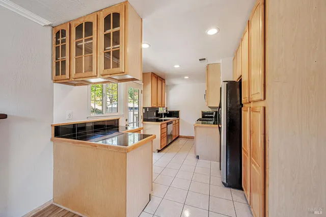 a kitchen with stainless steel appliances granite countertop a refrigerator and a stove