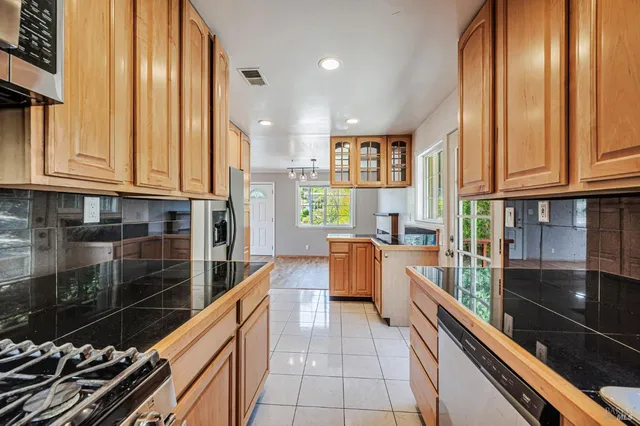 a view of a kitchen with a refrigerator cabinets and wooden floor