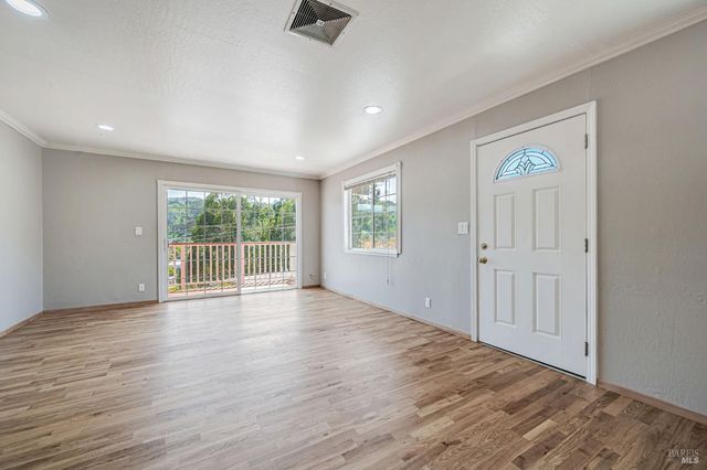 a living room with a fireplace and windows