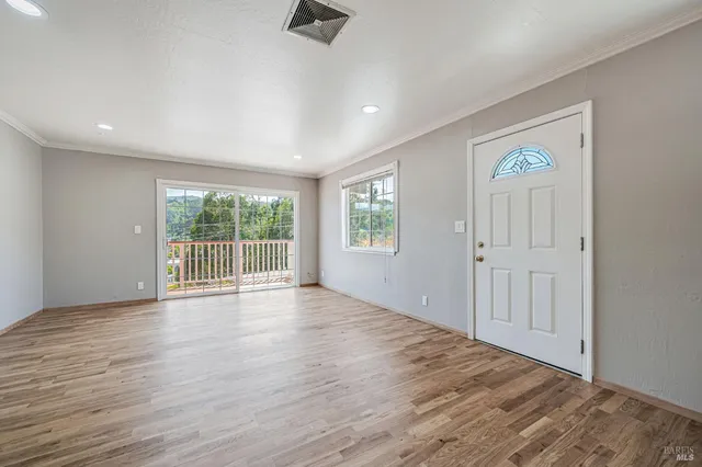a living room with a fireplace and windows