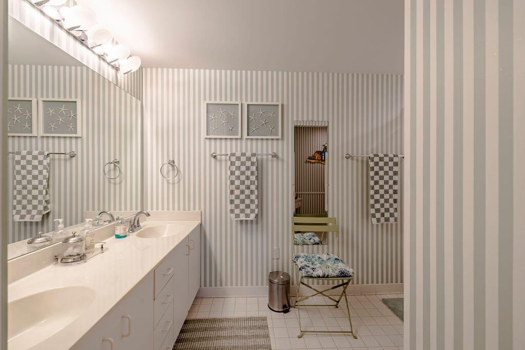 5520 East Harbor Village Drive, Unit 101 Vero Beach, FL 32967 - Photo 19 of 54 a bathroom with a sink and a mirror