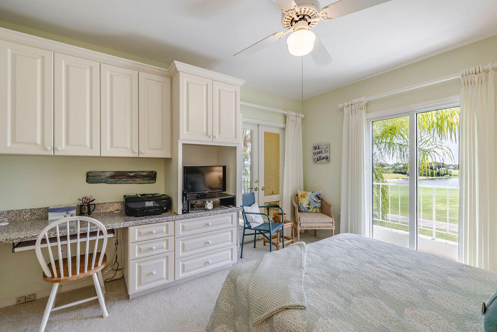 5520 East Harbor Village Drive, Unit 101 Vero Beach, FL 32967 - Photo 24 of 54 a kitchen with a stove a table and chairs
