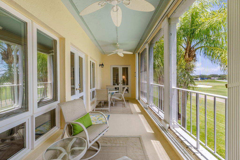 5520 East Harbor Village Drive, Unit 101 Vero Beach, FL 32967 - Photo 35 of 54 a view of a patio with table and chairs and wooden floor