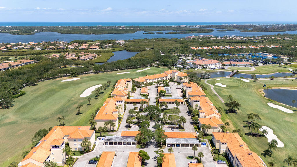 5520 East Harbor Village Drive, Unit 101 Vero Beach, FL 32967 - Photo 42 of 54 an aerial view of residential building and lake