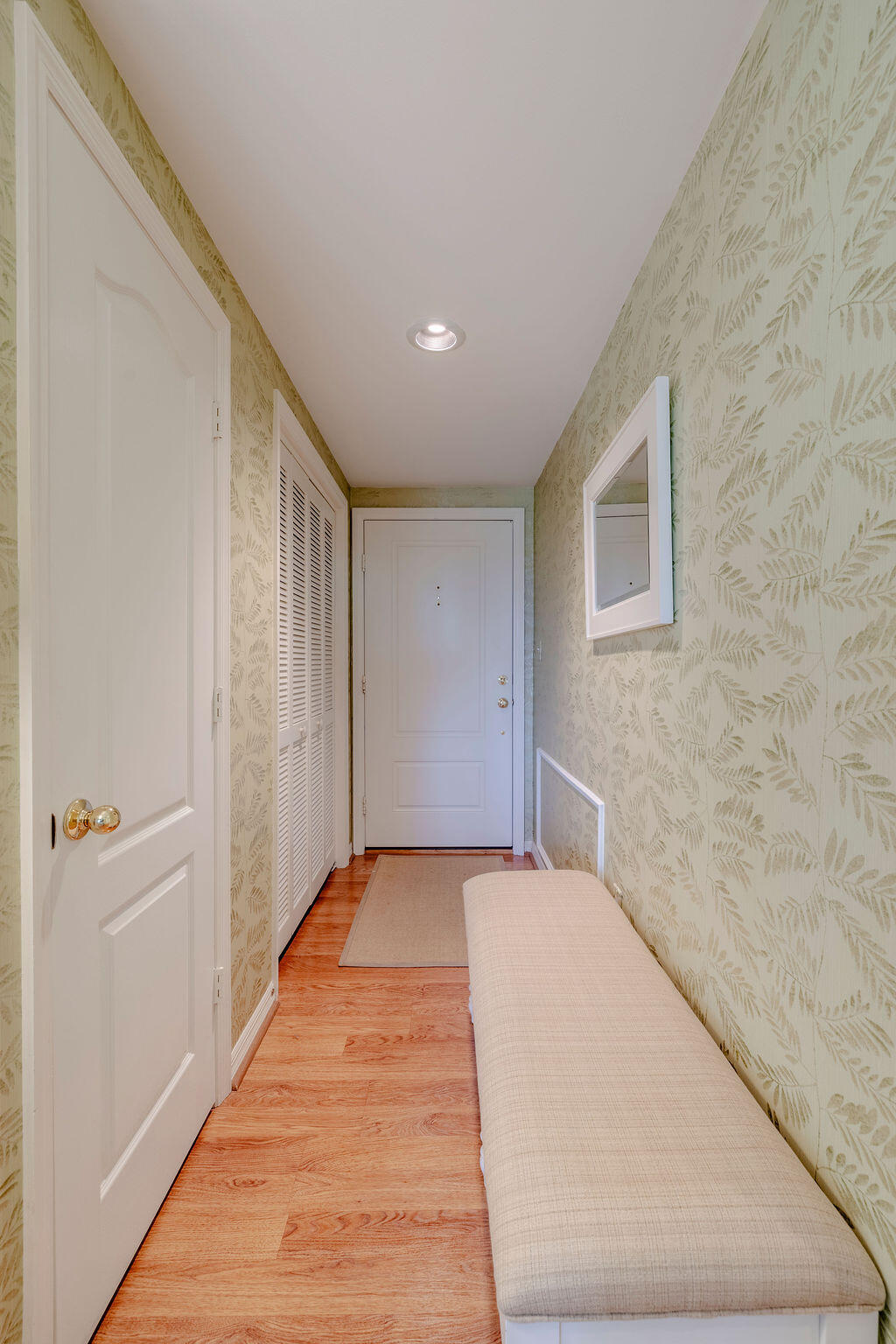 5520 East Harbor Village Drive, Unit 101 Vero Beach, FL 32967 - Photo 8 of 54 a view of a livingroom with an empty space and a hallway