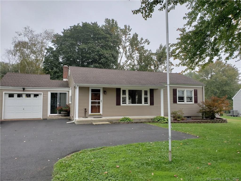 150 Shunpike Road Cromwell, CT 06416 - Photo 1 of 1 a front view of a house with a garden and trees
