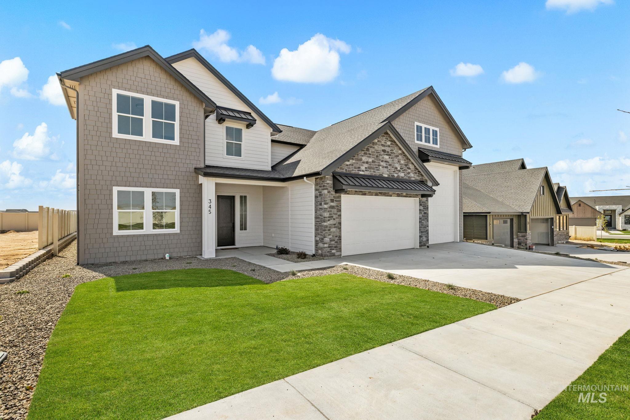 345 South Strut Way Boise, ID 83716 - Photo 2 of 50 Contemporary multi-level exterior featuring shingle siding, stone accents, and an attached two-car garage
