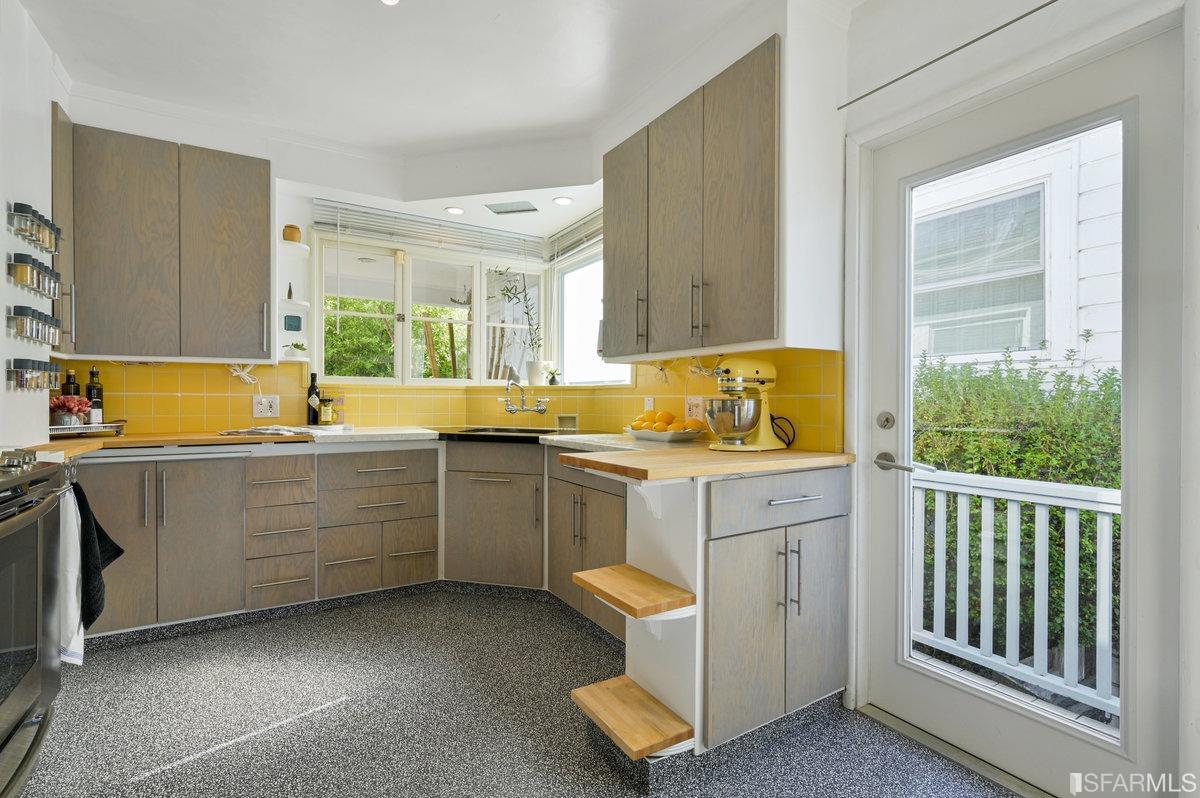 256 Columbia Avenue Kensington, CA 94708 - Photo 12 of 37 a kitchen with sink cabinets and wooden floor