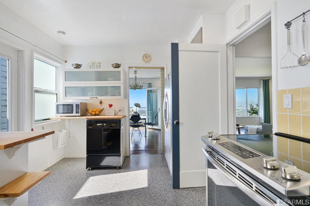 256 Columbia Avenue Kensington, CA 94708 - Photo 13 of 37 a kitchen with kitchen island a counter and a refrigerator