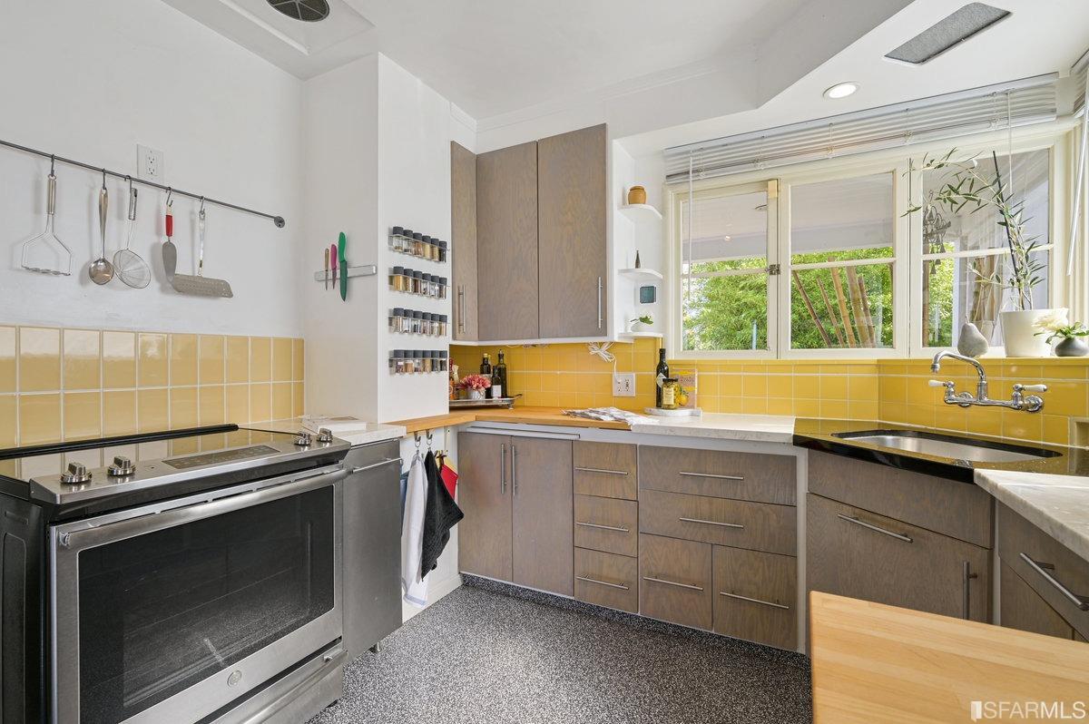 256 Columbia Avenue Kensington, CA 94708 - Photo 14 of 37 a kitchen with stainless steel appliances a stove sink and window
