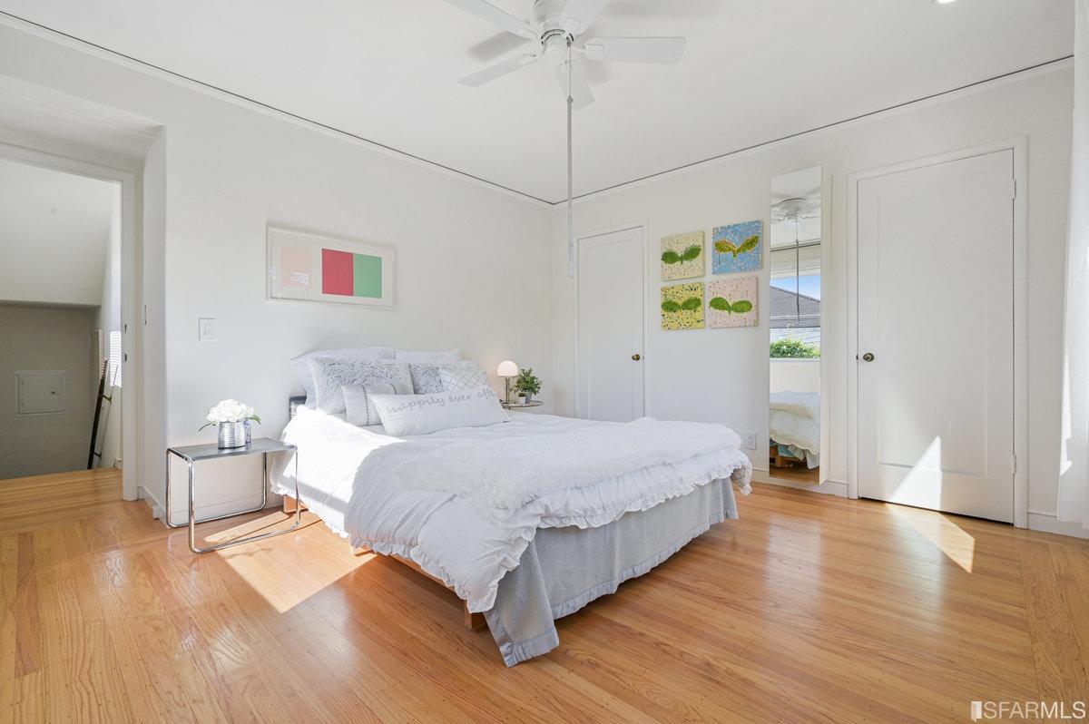 256 Columbia Avenue Kensington, CA 94708 - Photo 22 of 37 a spacious bedroom with a bed and a chandelier