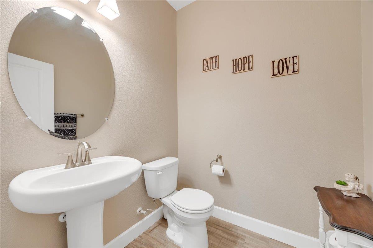 133 Palisades Place Copperopolis, CA 95228 - Photo 54 of 95 a bathroom with a toilet sink and mirror