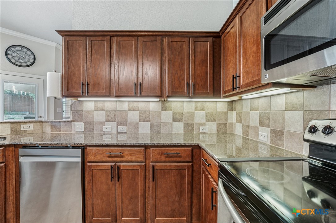 5420 Foxhill Road Temple, TX 76502 - Photo 15 of 47 a kitchen with granite countertop cabinets and a stove top oven