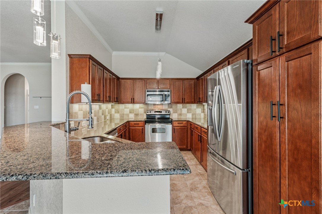 5420 Foxhill Road Temple, TX 76502 - Photo 17 of 47 a kitchen with stainless steel appliances granite countertop a sink refrigerator and cabinets