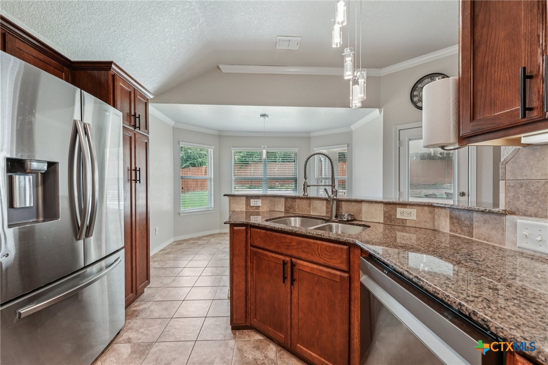 5420 Foxhill Road Temple, TX 76502 - Photo 20 of 47 a kitchen with stainless steel appliances granite countertop a sink and a refrigerator