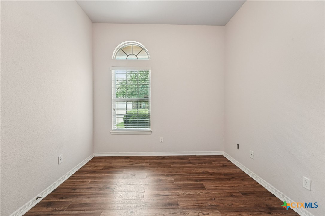 5420 Foxhill Road Temple, TX 76502 - Photo 34 of 47 a view of an empty room with wooden floor and a window