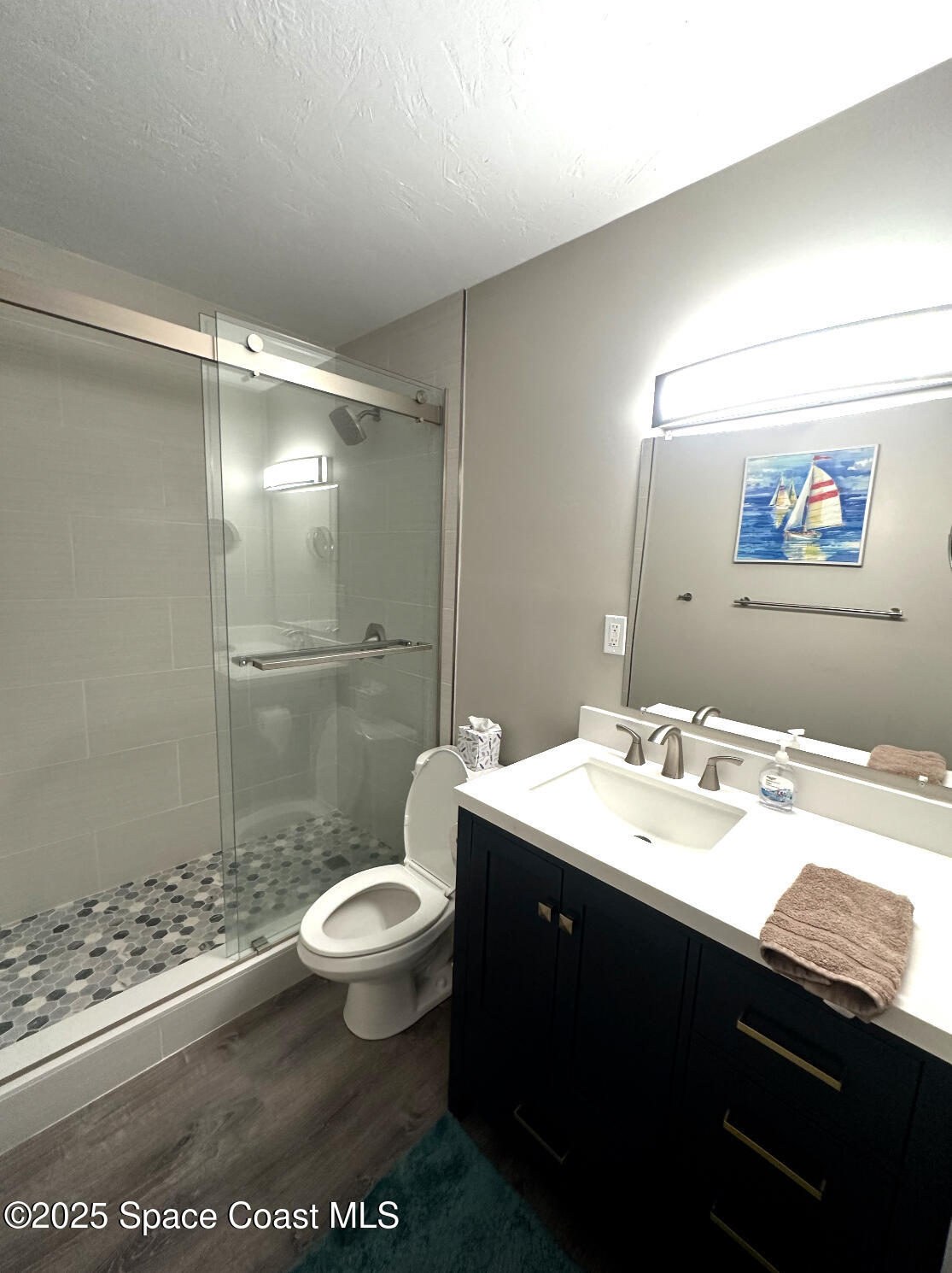 171 North Atlantic Avenue, Unit 39 Cocoa Beach, FL 32931 - Photo 15 of 29 a bathroom with a granite countertop sink toilet and shower