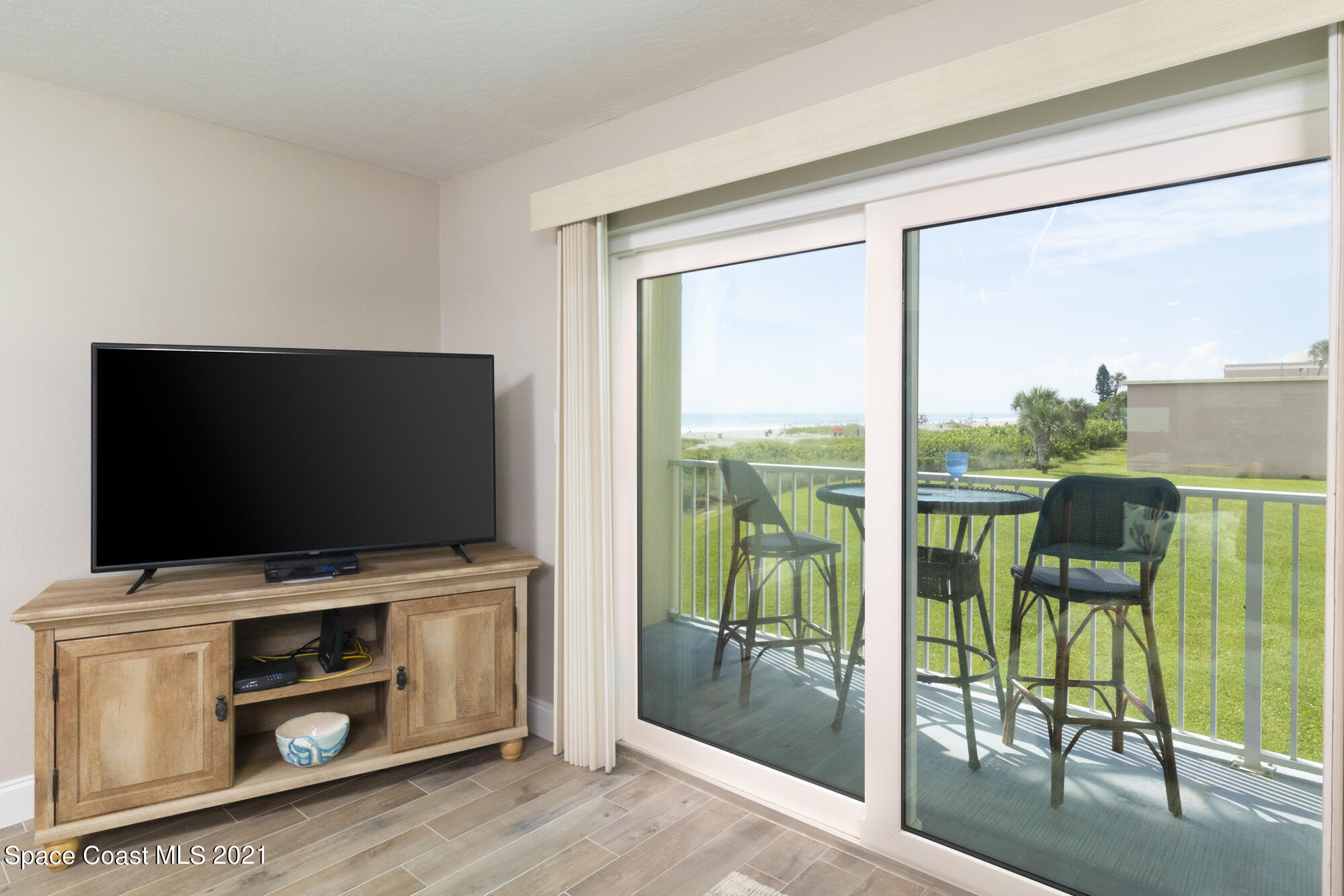 171 North Atlantic Avenue, Unit 39 Cocoa Beach, FL 32931 - Photo 8 of 29 a view of a livingroom with furniture and a flat screen tv
