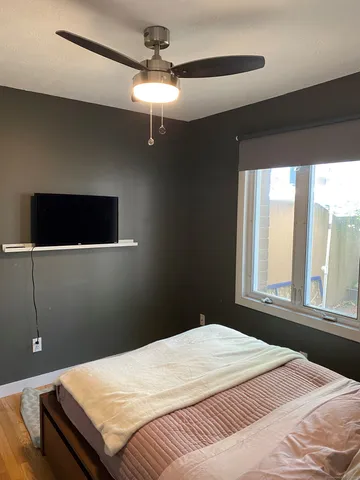 a bedroom with a bed and a window