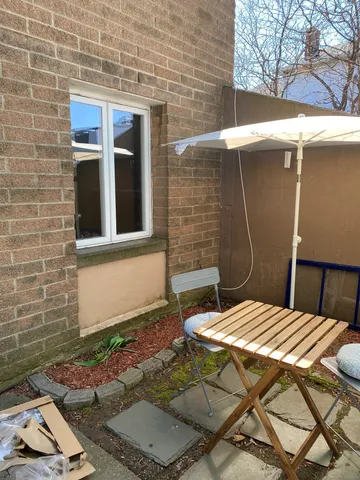 a backyard of a house with table and chairs