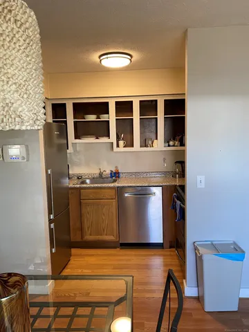 a view of kitchen with granite countertop window and stainless steel appliances