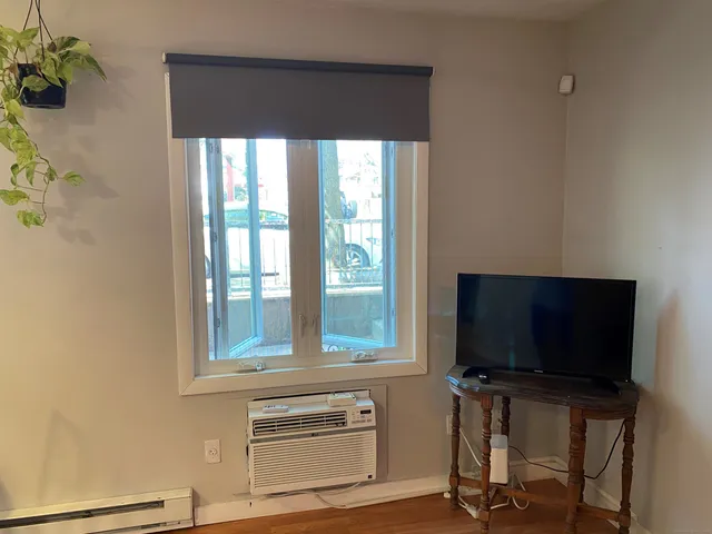 a living room with a flat screen tv and a window
