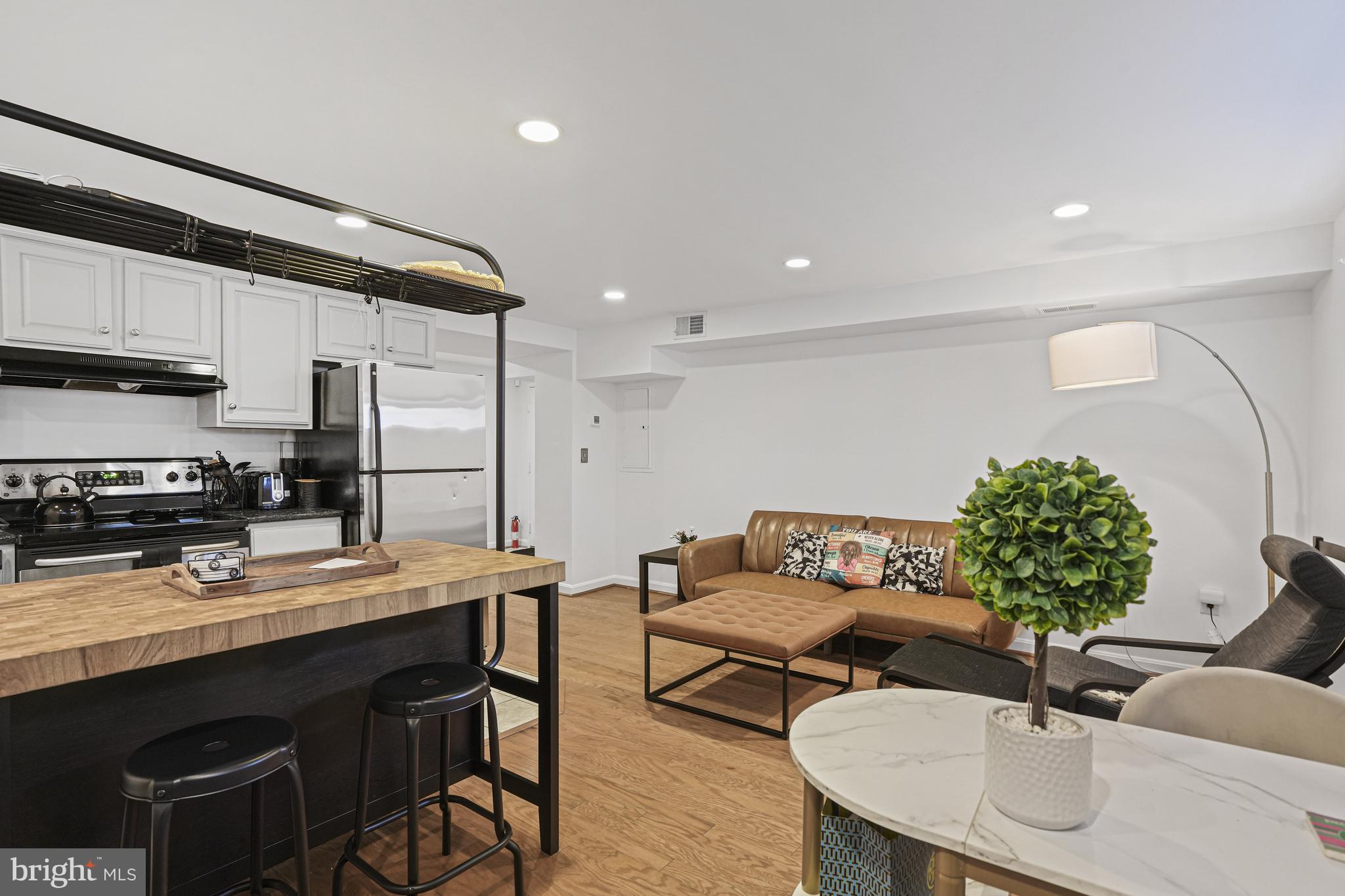 1321 Fairmont Street Northwest, Unit 1 Washington, DC 20009 - Photo 1 of 22 a living room with furniture and a wooden floor