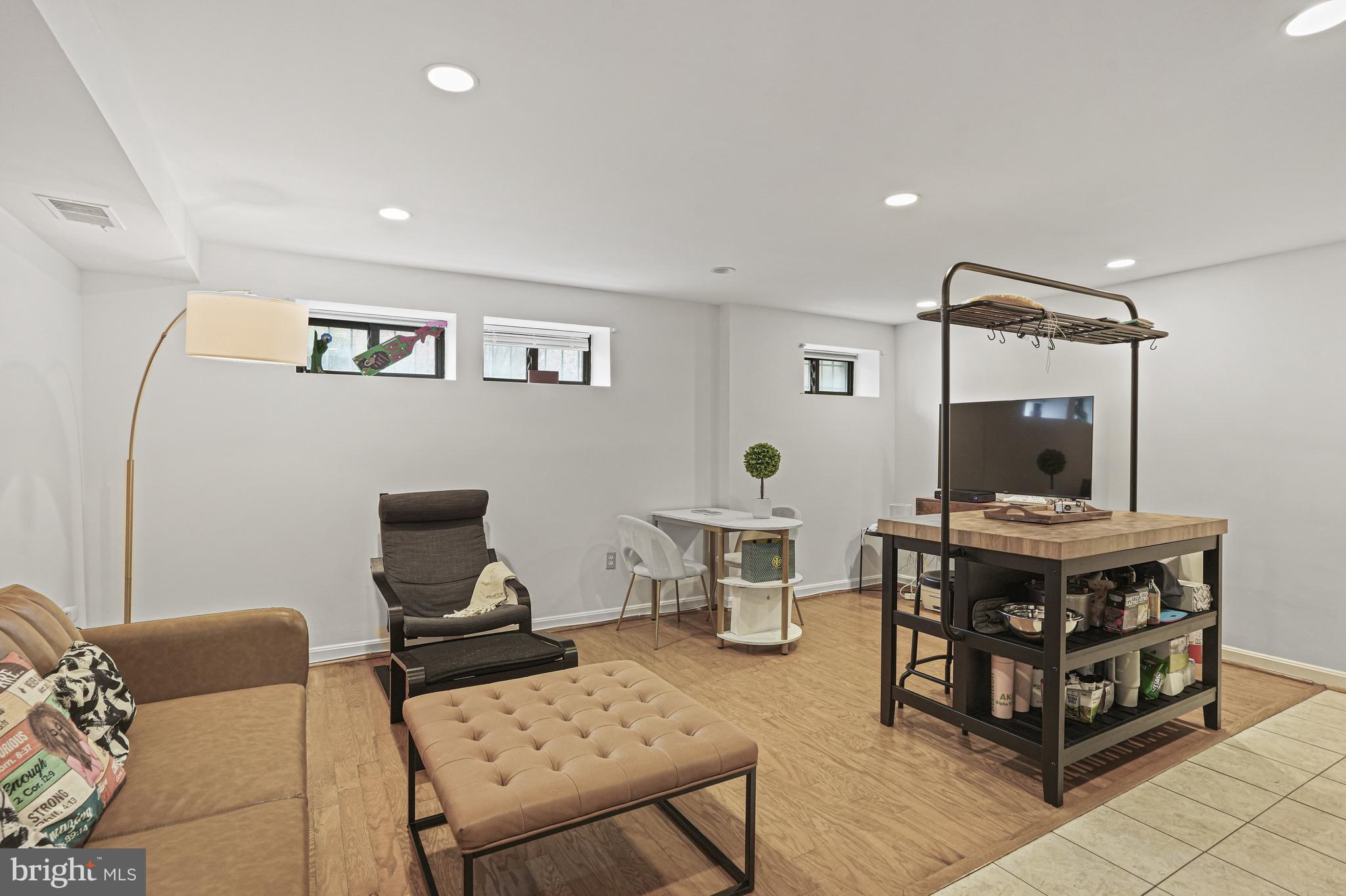 1321 Fairmont Street Northwest, Unit 1 Washington, DC 20009 - Photo 14 of 22 a living room with furniture and a flat screen tv
