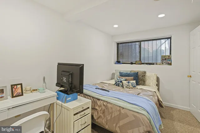 a bedroom with a bed and a television