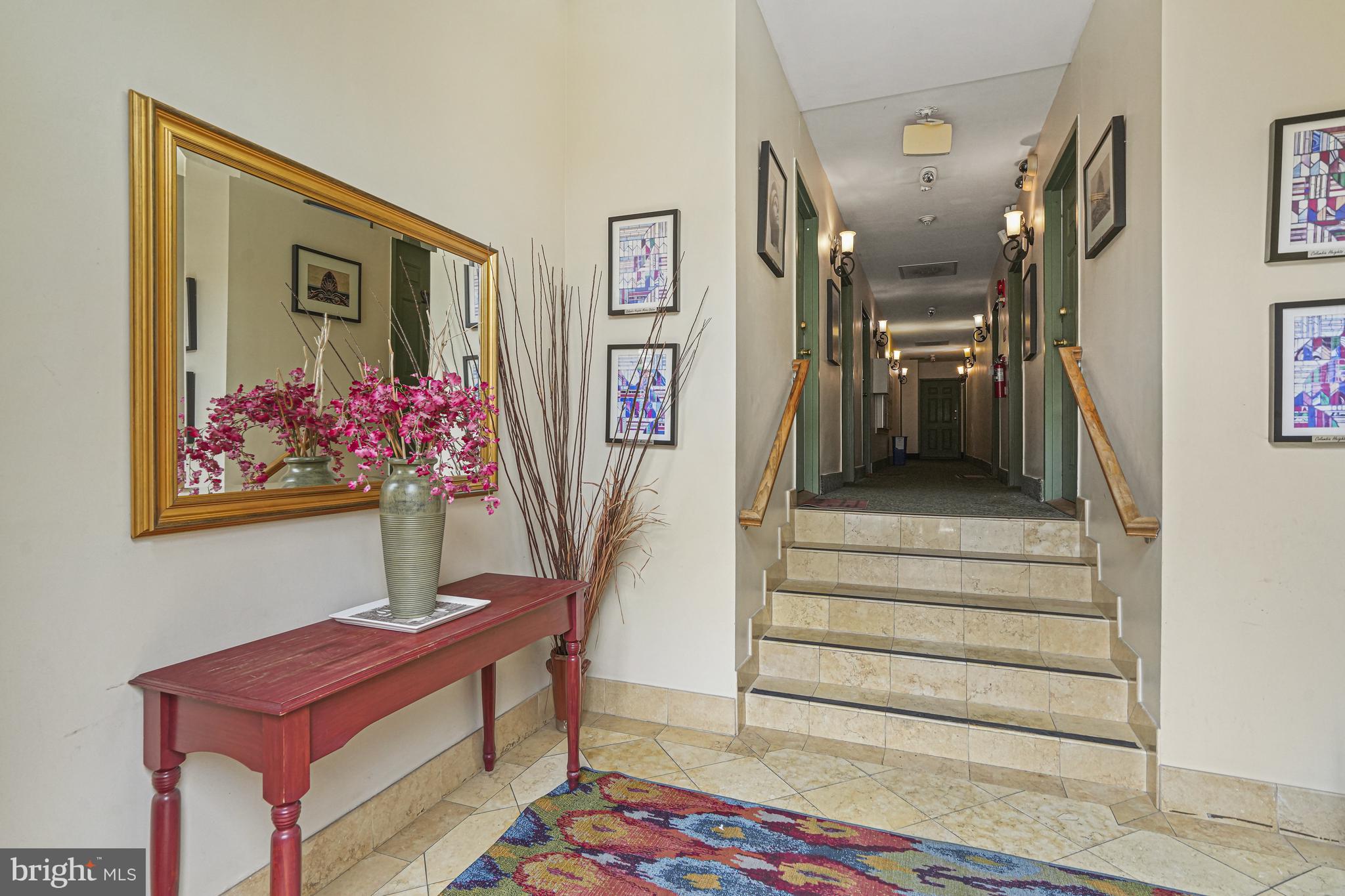 1321 Fairmont Street Northwest, Unit 1 Washington, DC 20009 - Photo 7 of 22 a hallway view with furniture and paintings on the wall