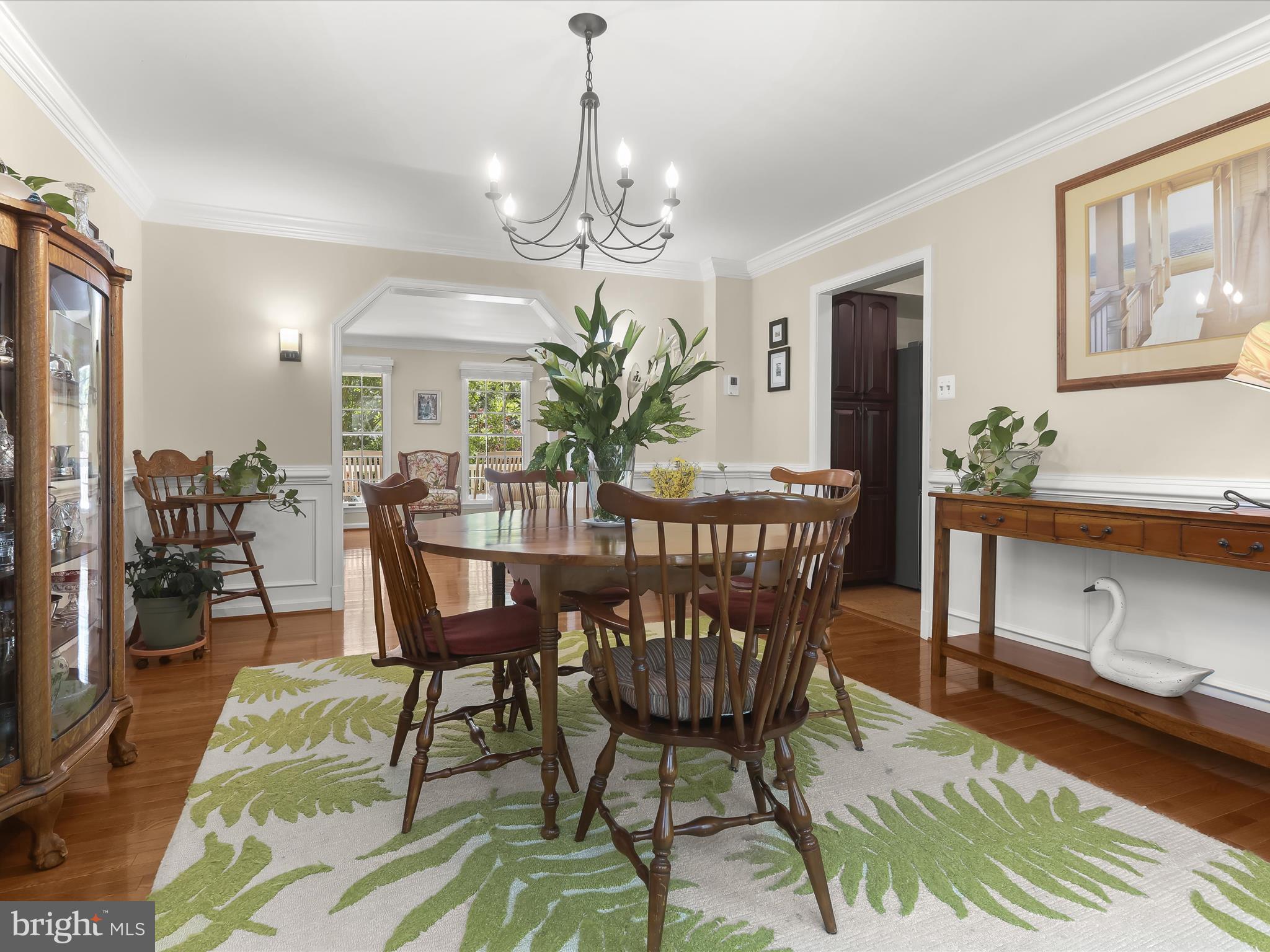 10634 Quarterstaff Road Columbia, MD 21044 - Photo 19 of 62 a dining room with furniture a chandelier and wooden floor