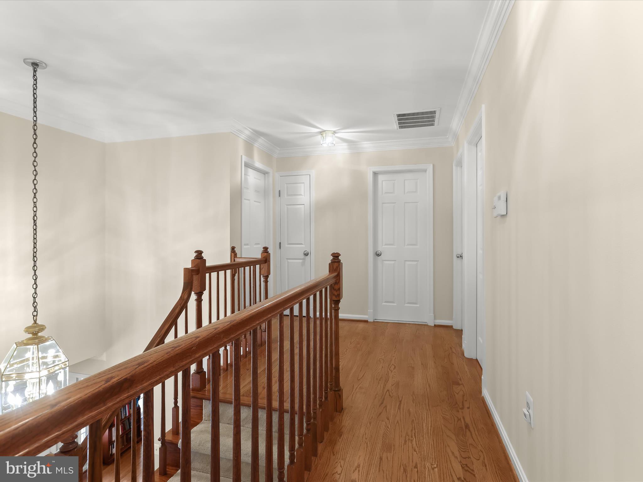 10634 Quarterstaff Road Columbia, MD 21044 - Photo 33 of 62 a view of a hallway with wooden floor and staircase