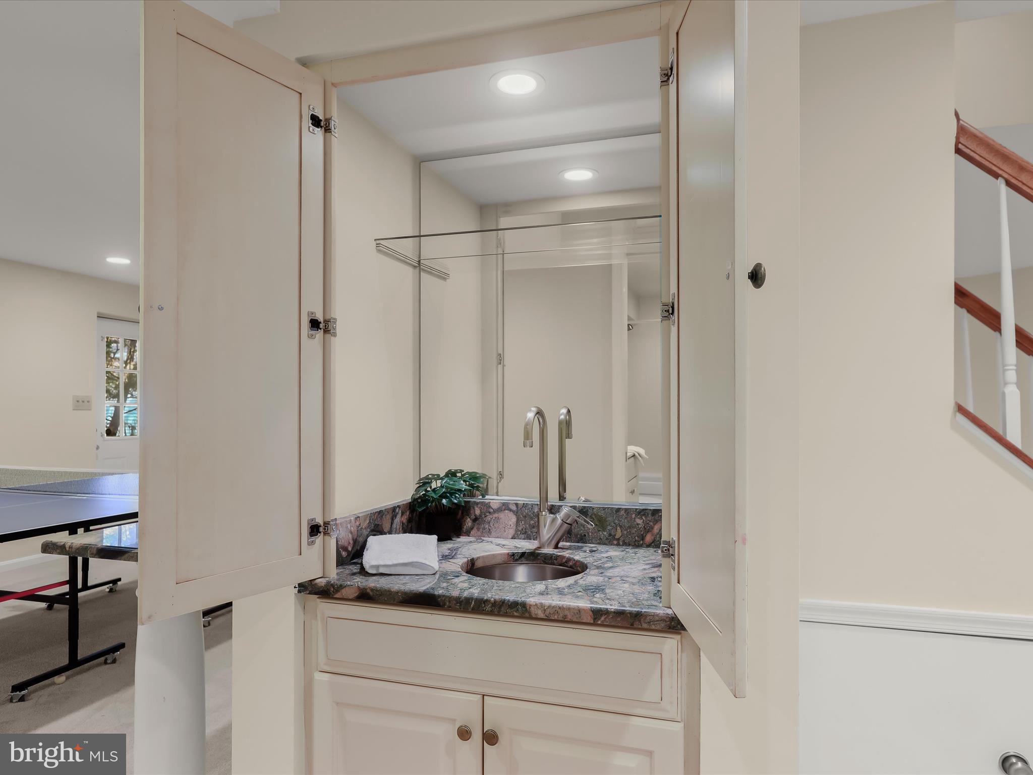 10634 Quarterstaff Road Columbia, MD 21044 - Photo 46 of 62 a bathroom with a granite countertop sink and a mirror