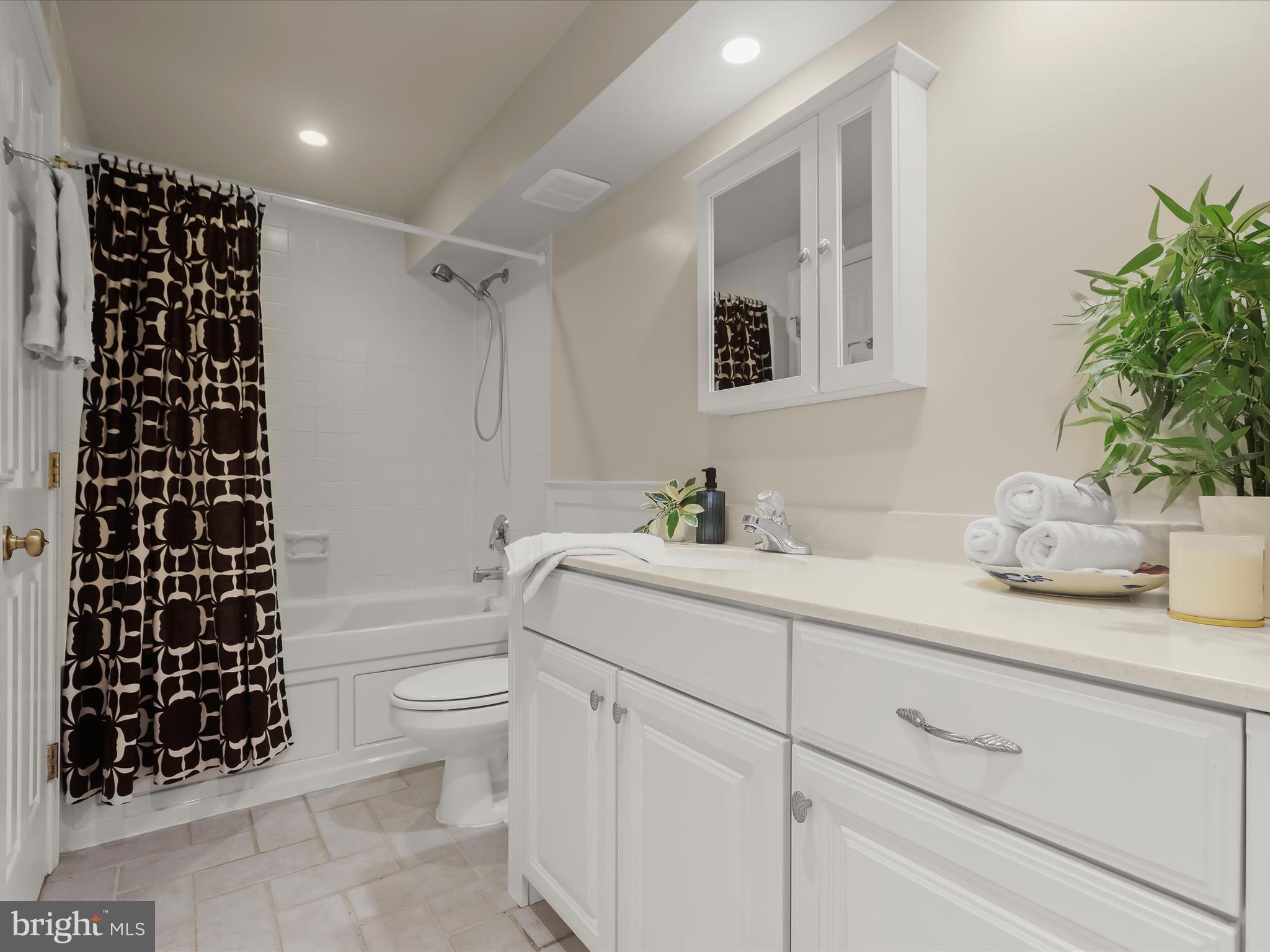 10634 Quarterstaff Road Columbia, MD 21044 - Photo 47 of 62 a bathroom with a granite countertop sink a toilet and a mirror