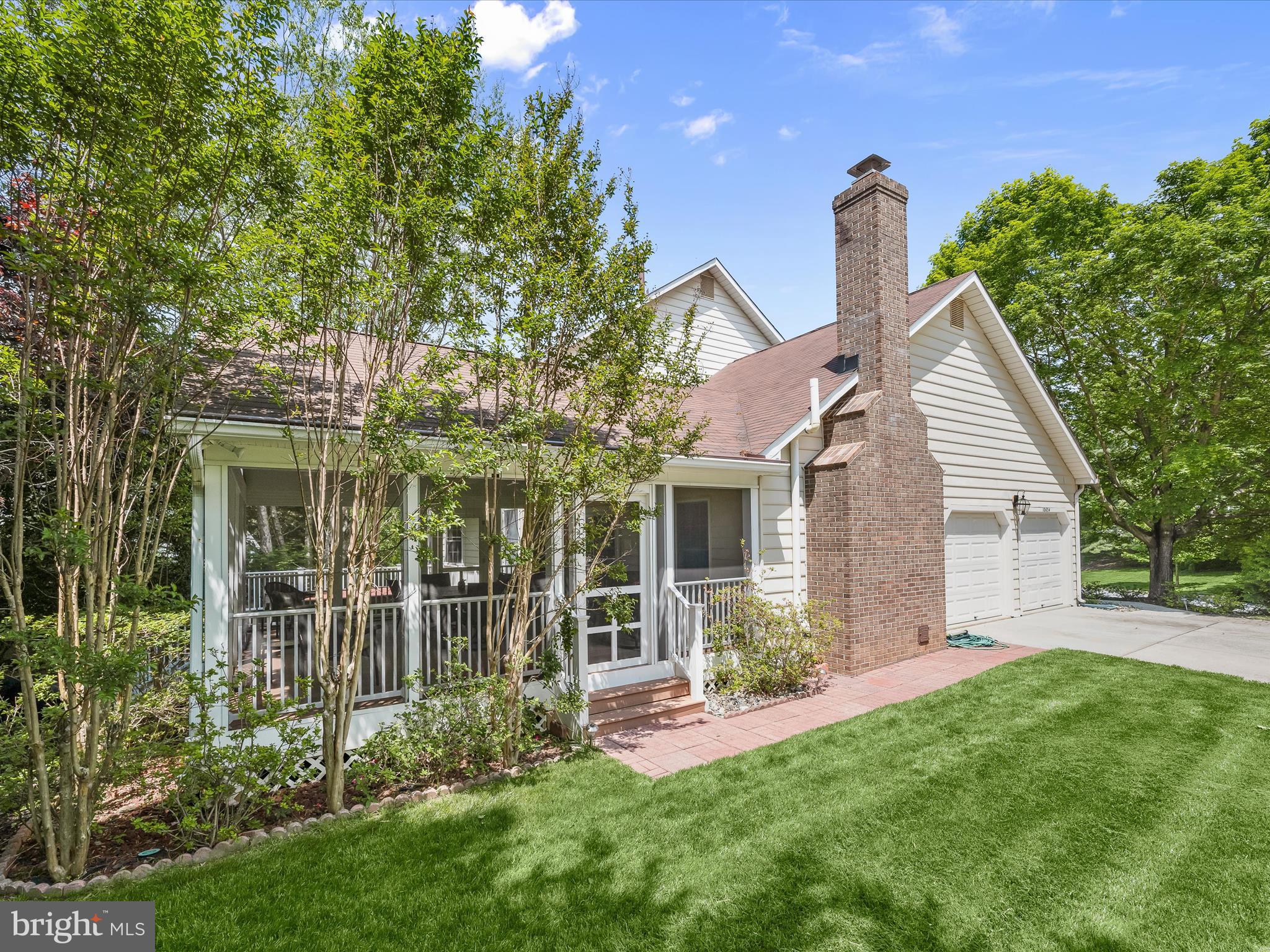 10634 Quarterstaff Road Columbia, MD 21044 - Photo 56 of 62 a front view of a house with a garden and plants