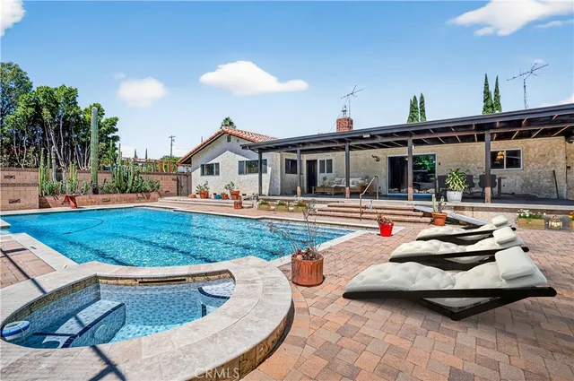a backyard of a house with table and chairs