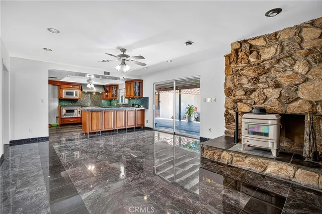 a kitchen with stainless steel appliances granite countertop a stove a sink and a microwave