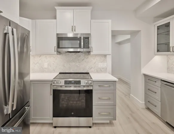 a kitchen with stainless steel appliances granite countertop a stove and a refrigerator