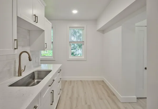 a kitchen with a sink and cabinets