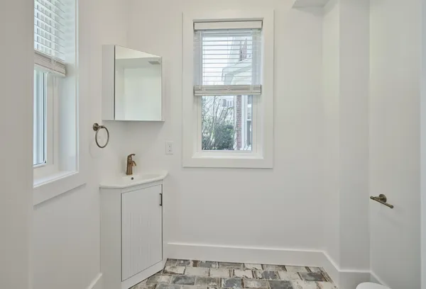 a bathroom with a sink and window