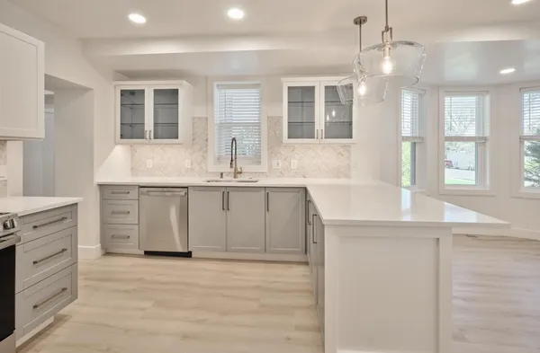 a kitchen with a sink stove and cabinets