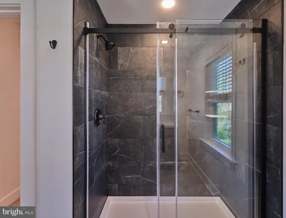 a bathroom with a glass shower door